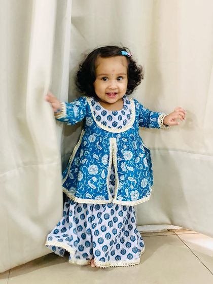 My daughter in a beautiful blue and white block-printed ethnic set for her first Raksha Bandhan. She looks like a little doll.