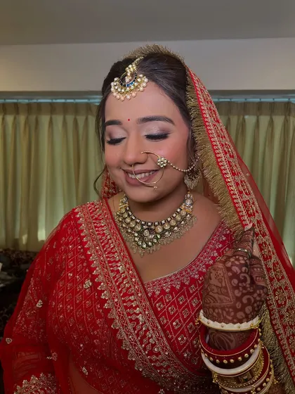 A serene portrait of the bride. The simple, elegant updo provides a perfect base for the dupatta, completing the timeless bridal look.
