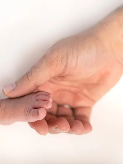 Sometimes the smallest details hold the biggest love. I always make sure to capture close-up shots, like these tiny baby feet held in a parent's hand, to remember just how little they once were.