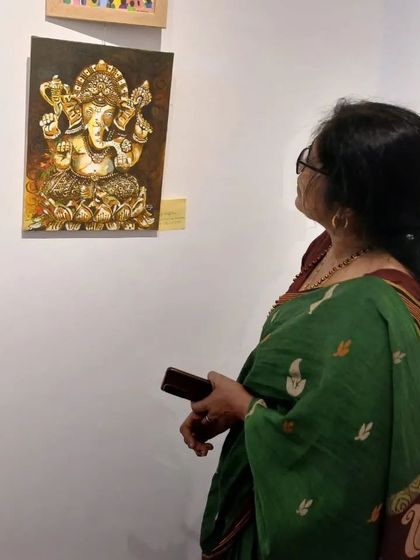 A visitor taking a closer look at my textured Ganesha painting.