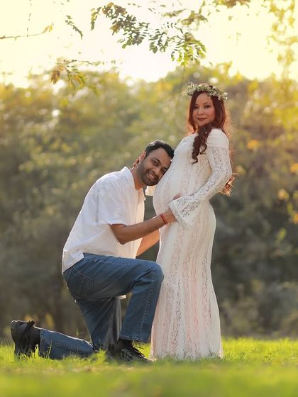 A classic and tender pose, with the husband-to-be kneeling to listen to the baby bump. This shot beautifully captures his connection with the baby.