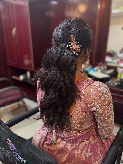 Another view of Surya's textured ponytail. This modern hairstyle is a great alternative to traditional updos and adds a touch of contemporary flair.