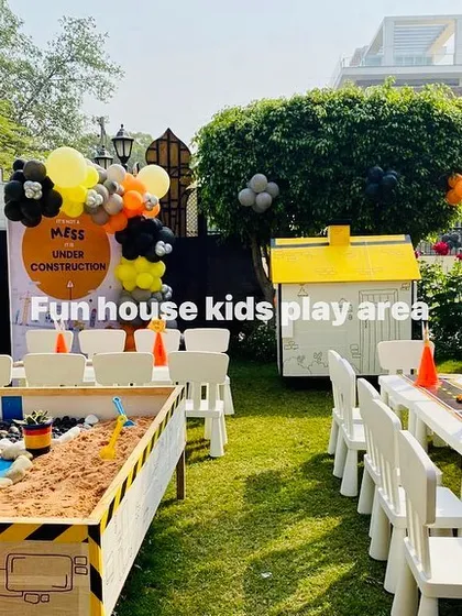 Let's get building! This construction-themed party setup features our interactive sandpit, a dedicated activity table with a road-themed runner, and our versatile white chairs, creating a zone for imaginative play and hands-on fun.