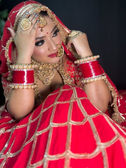 Another beautiful pose from the bride in the red lehenga, showcasing the versatility of her look for the wedding photoshoot.
