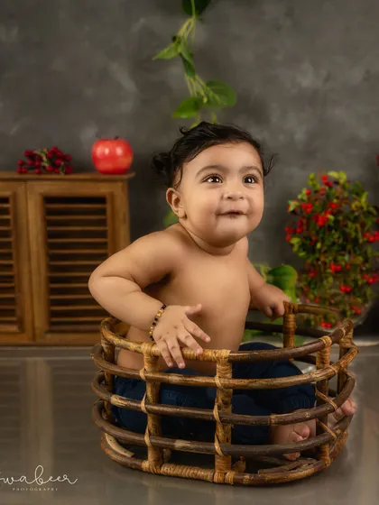 A cheeky grin from inside a basket. This baby's personality shines in this rustic, farm-inspired milestone session.