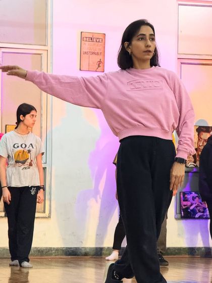 A student holding a pose with grace. Our classes blend different styles, including elements of jazz and commercial dance.