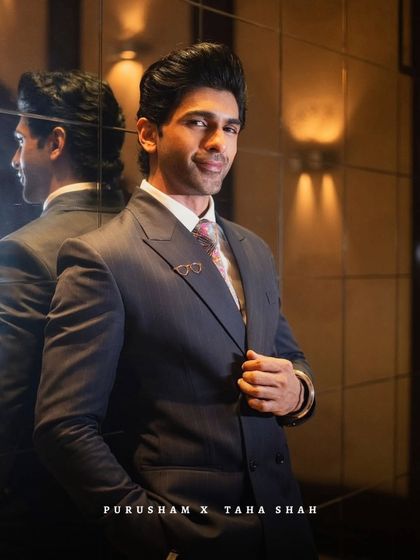 Double the charm, single focus. Taha Shah in a classic navy suit, where my vision of confidence meets couture.