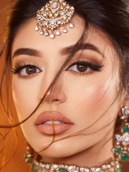 A dreamy, windswept shot that highlights the flawless makeup and signature liner.
