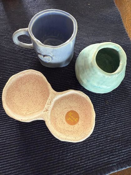 A collection of recent student pieces: a heart-stamped mug, a small vase, and a double dip dish. So much variety!