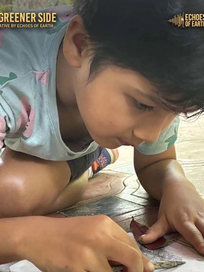 A child deeply focused on creating a leaf rubbing, a classic and beloved nature journaling activity.