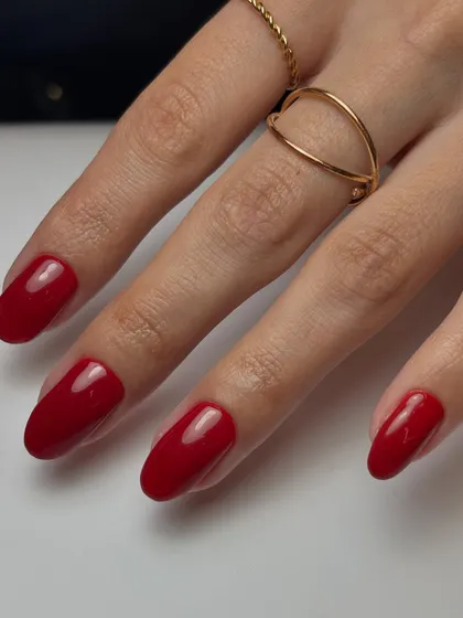 You can never go wrong with a classic. This is a vibrant, classic red manicure on beautifully shaped almond nails for a look that is always in style.