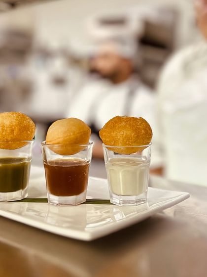 Our puchkas ready for service, with the crisp shells resting atop shots of differently flavoured waters. It’s a visual and culinary delight that is always a favourite.