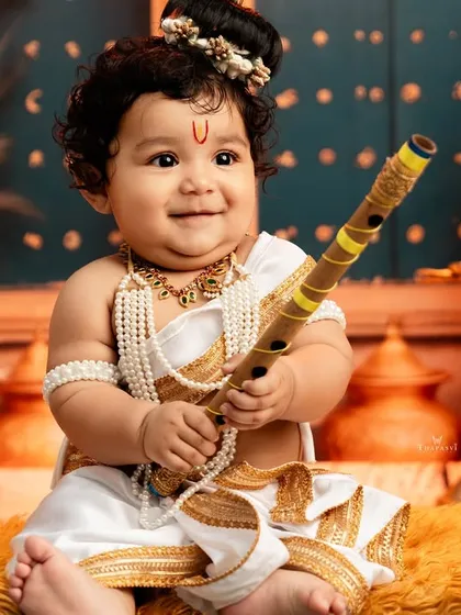 Celebrating cultural heritage is a passion of mine. This Little Krishna portrait, with its detailed setup and the baby's joyful expression, showcases my ability to create stunning, traditional photoshoots that honor your family's roots.
