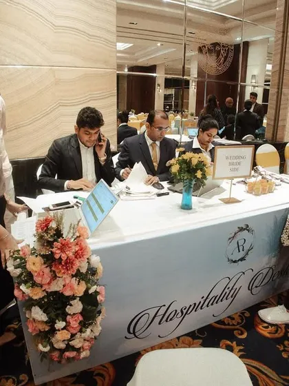 Even the functional areas deserve a touch of elegance. I decorated the hospitality desk with a floral runner and a custom-branded table skirt to ensure a seamless and beautiful guest experience.