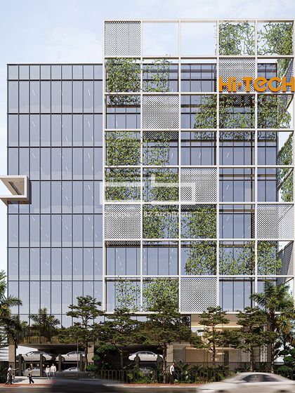 In this office building, the facade features a grid-like exterior adorned with greenery, reflecting a commitment to sustainability. The expansive glass panels and integrated natural elements create a fresh and vibrant atmosphere.