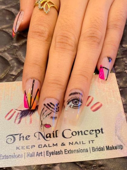 A unique, abstract design on a single long nail. This piece of art features a hand-painted eye, lips, and geometric patterns in multiple colors.