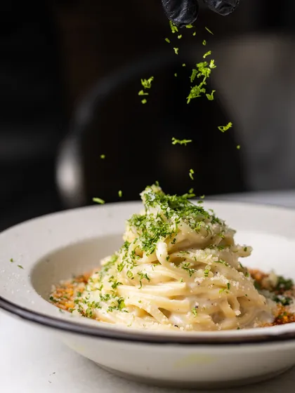 A final sprinkle of fresh parsley adds a touch of freshness and color to my signature Vodka Pasta before it's served.