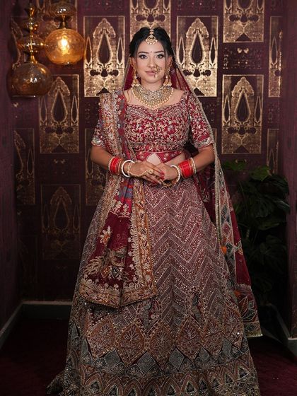 Another angle of this gorgeous maroon bridal lehenga, showing how it drapes beautifully. I ensure every outfit is perfectly fitted for my brides.