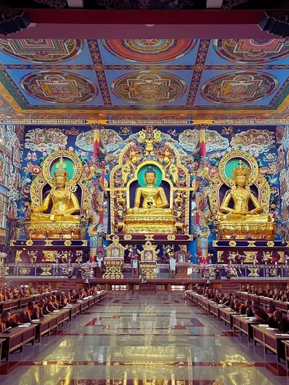 Inside the main prayer hall of the Golden Temple, with its magnificent golden Buddha statues. The scale and detail are breathtaking.