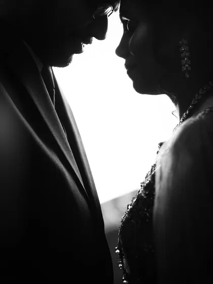A powerful silhouette of a couple, their faces close together. This black and white image is all about intimacy and emotion, stripping away all distractions to focus on their bond.