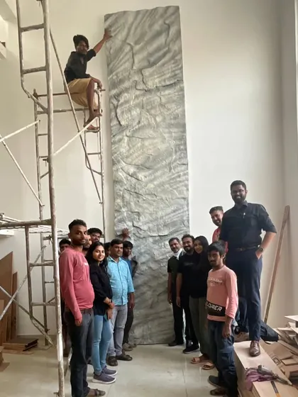 Our team on site, installing a custom-sculpted stone panel. This piece was designed to bring the rugged beauty of the adjacent quarry into the heart of the home, a testament to our hands-on approach and commitment to artistry.