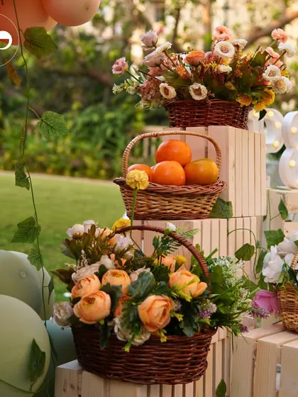 Baskets of fresh oranges and flowers add a rustic, natural element to a 'Little Cutie' themed baby shower. I love using fresh, thematic props to enhance the decor.
