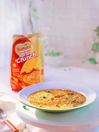 A bright, clean shot of Saffola Masala Oats, styled to look like a warm and comforting meal, perfect for packaging or advertising.