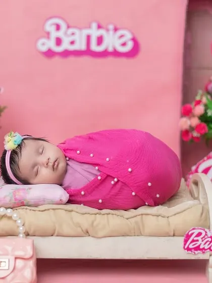 A real-life Barbie girl! This all-pink, Barbie-themed newborn shoot is perfect for your little princess, complete with a miniature bed and accessories.