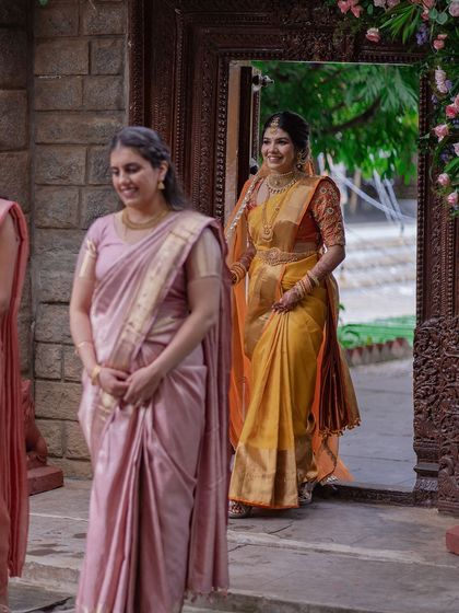 The bride, accompanied by her bridesmaids, makes her way to the ceremony.