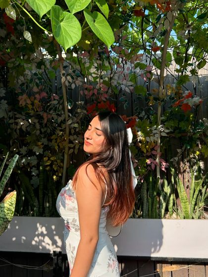 A smiling, sun-kissed shot at the cafe. This captures a perfect brunch-time mood.