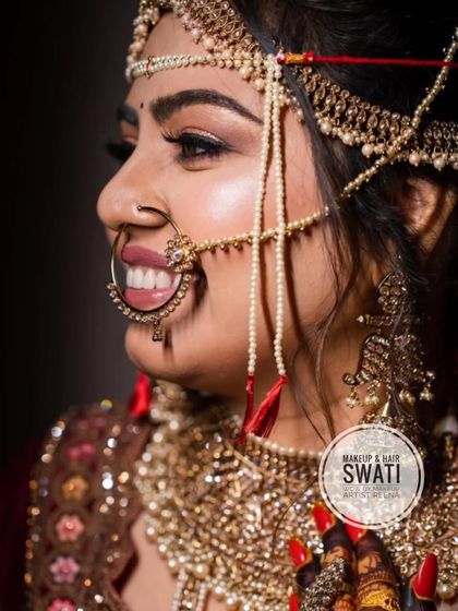 A side profile showcasing Henoy's intricate bridal jewellery and the flawless makeup application by Swati.