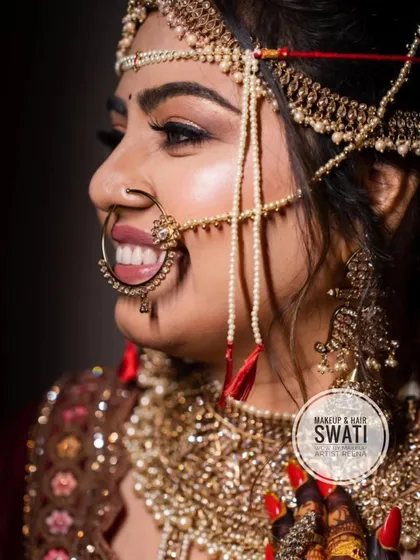A side profile showcasing Henoy's intricate bridal jewellery and the flawless makeup application by Swati.