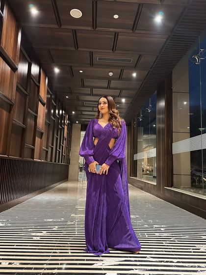 This modern purple saree with dramatic sleeves is a perfect example of my style. It's elegant, contemporary, and makes a bold statement, ideal for a stylish cocktail event.