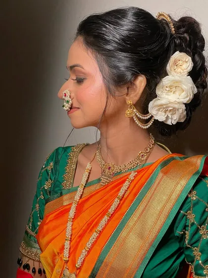 A side profile showcasing the elegant bridal bun adorned with fresh white roses, a classic choice for a Maharashtrian wedding.