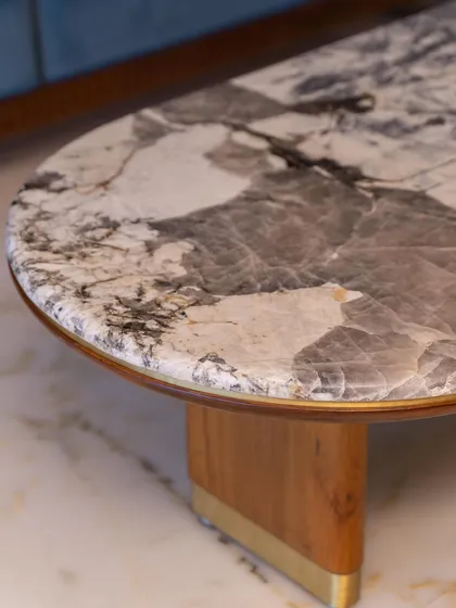 This custom center table, with its beautiful marble top and unique base, is designed to be a charming and functional centerpiece.
