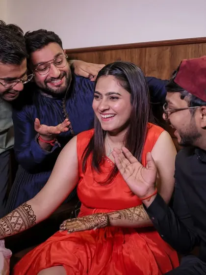The bride sharing a laugh with her friends and family as they admire her Mehandi. Capturing these group dynamics is key.