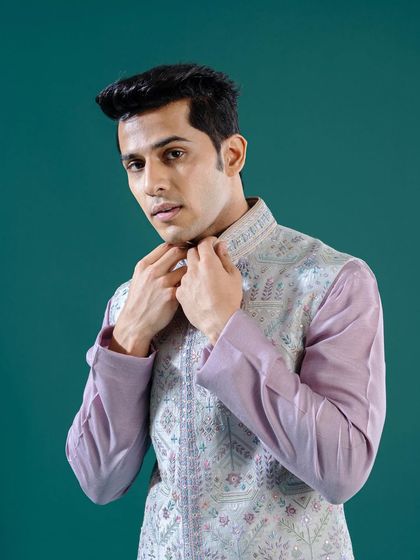 A close-up on a pastel lilac Jawahar jacket, highlighting the intricate embroidery and delicate color palette. This piece is a wardrobe essential for any intimate soirée or celebration.