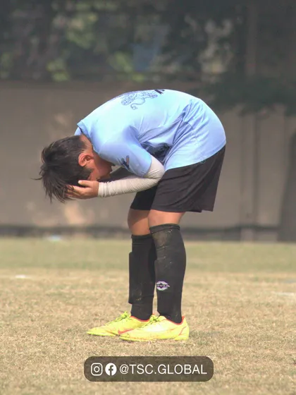 The emotion of the game. A player reacts to a missed chance, showing how much it means to them.