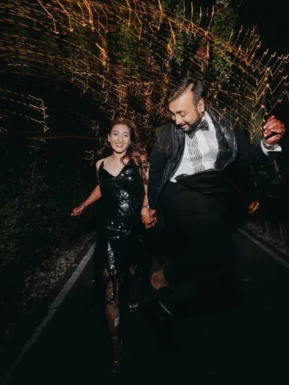 A fun and spontaneous shot of the couple jumping for joy. We love capturing these moments of pure, uninhibited happiness that show the couple's personality.