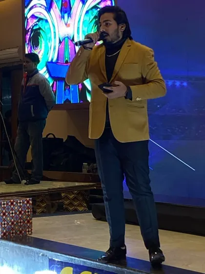 A shot of me on stage during an evening event. Whether it's a large sangeet or an intimate gathering, I am comfortable commanding the stage and keeping the audience engaged throughout the night.
