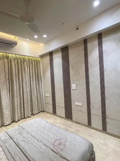 This bedroom design uses a combination of textured wallpaper and wood-look panels to create a warm and inviting atmosphere. The simple, clean lines ensure a minimalist and clutter-free feel.
