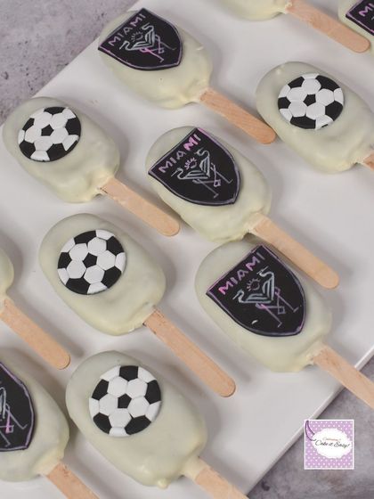 Matching the Messi theme, these cakesicles feature the Inter Miami logo and soccer ball designs. They are a great way to extend the theme across the entire dessert table.