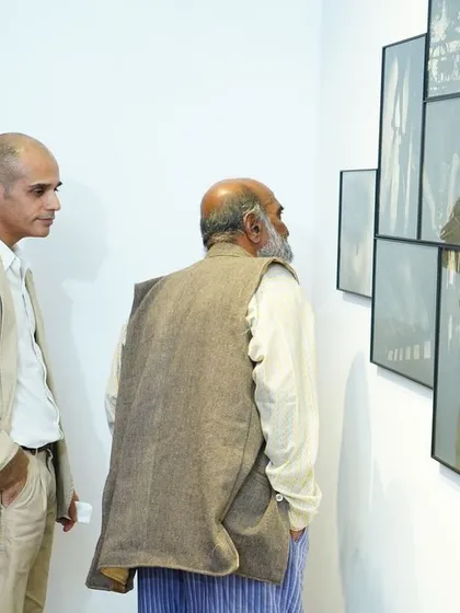 Visitors engaging with a large gumoil print collage at the Delhi exhibition. These events are a wonderful opportunity for us to connect with art lovers and discuss the stories behind the work.