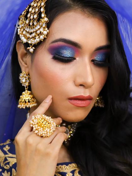 It's always fun to create colorful eye looks. This peacock-inspired eyeshadow with shades of blue, purple, and pink is perfect for a sangeet or mehendi.