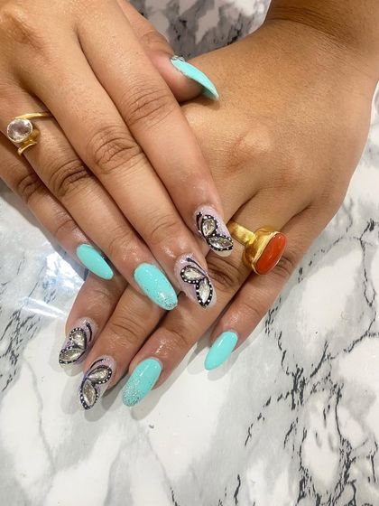 A beautiful turquoise set with stunning, hand-painted butterfly wing accents made from rhinestones.