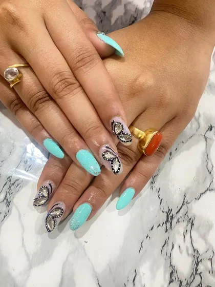 A beautiful turquoise set with stunning, hand-painted butterfly wing accents made from rhinestones.