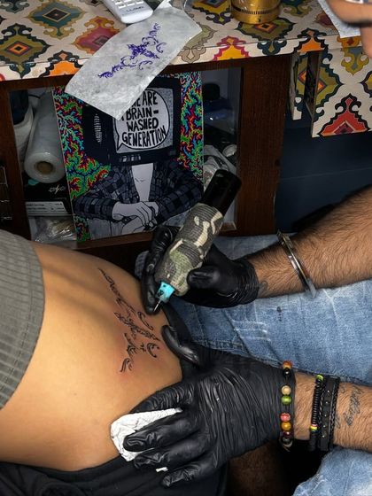 The process of wiping and cleaning a new tattoo. We follow strict hygiene protocols at every step.