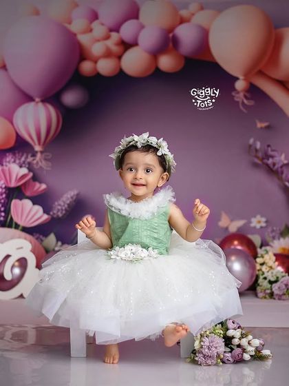 A beautiful first birthday setup with a lavender theme, complete with flowers and balloons, perfect for a little princess.