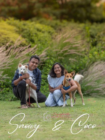 A lovely outdoor family portrait of Coco and Snowy with their parents, captured during a fun and slightly rebellious park session.