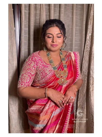 A beautiful portrait of Varsha with her eyes closed, showcasing the soft and shimmery eyeshadow look we created for her.